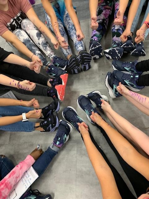 shoes and thumbs up from each participant in the shape of circle