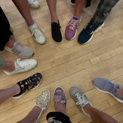 Event attendees sneakers in a circle